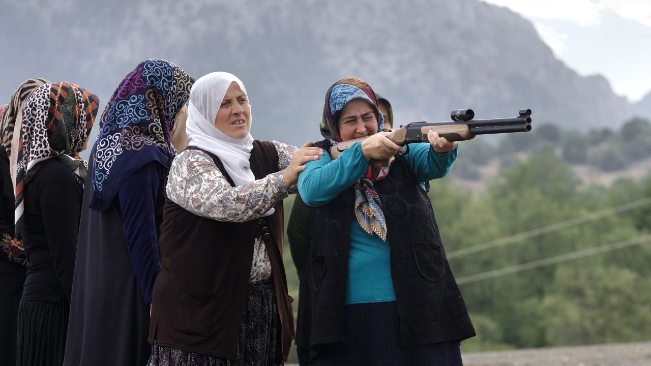 a group of women holding a gun